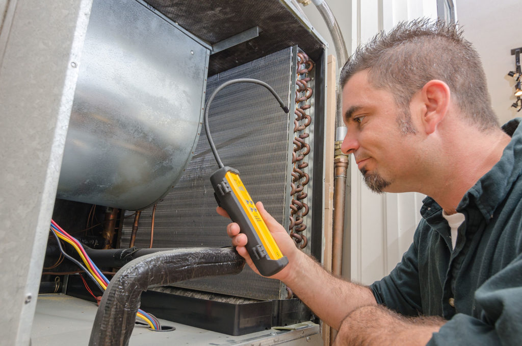 air-conditioning-repairman-testing-ac-warehouse